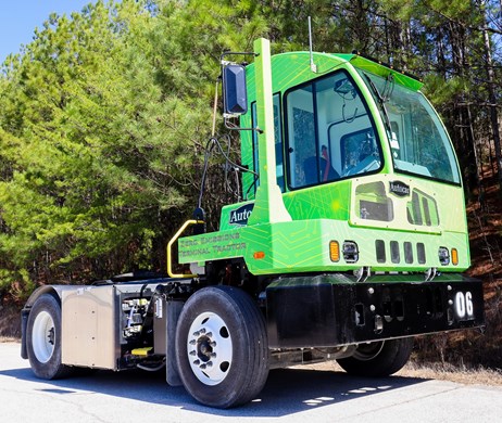 The Autocar E-ACTT all-electric terminal tractor with a green wrap. 