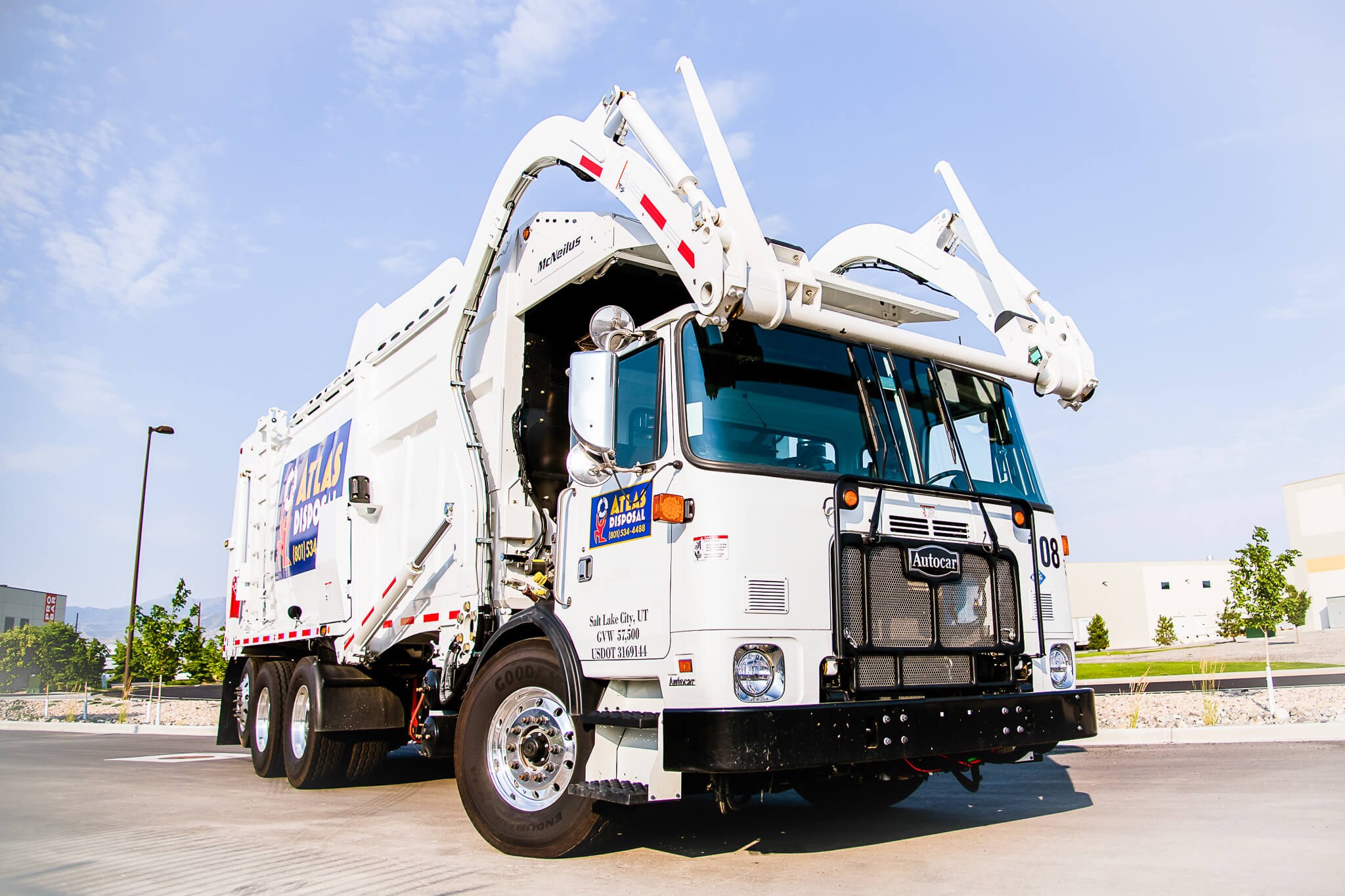 An Autocar severe duty ACX front end loader truck built for waste disposal. 